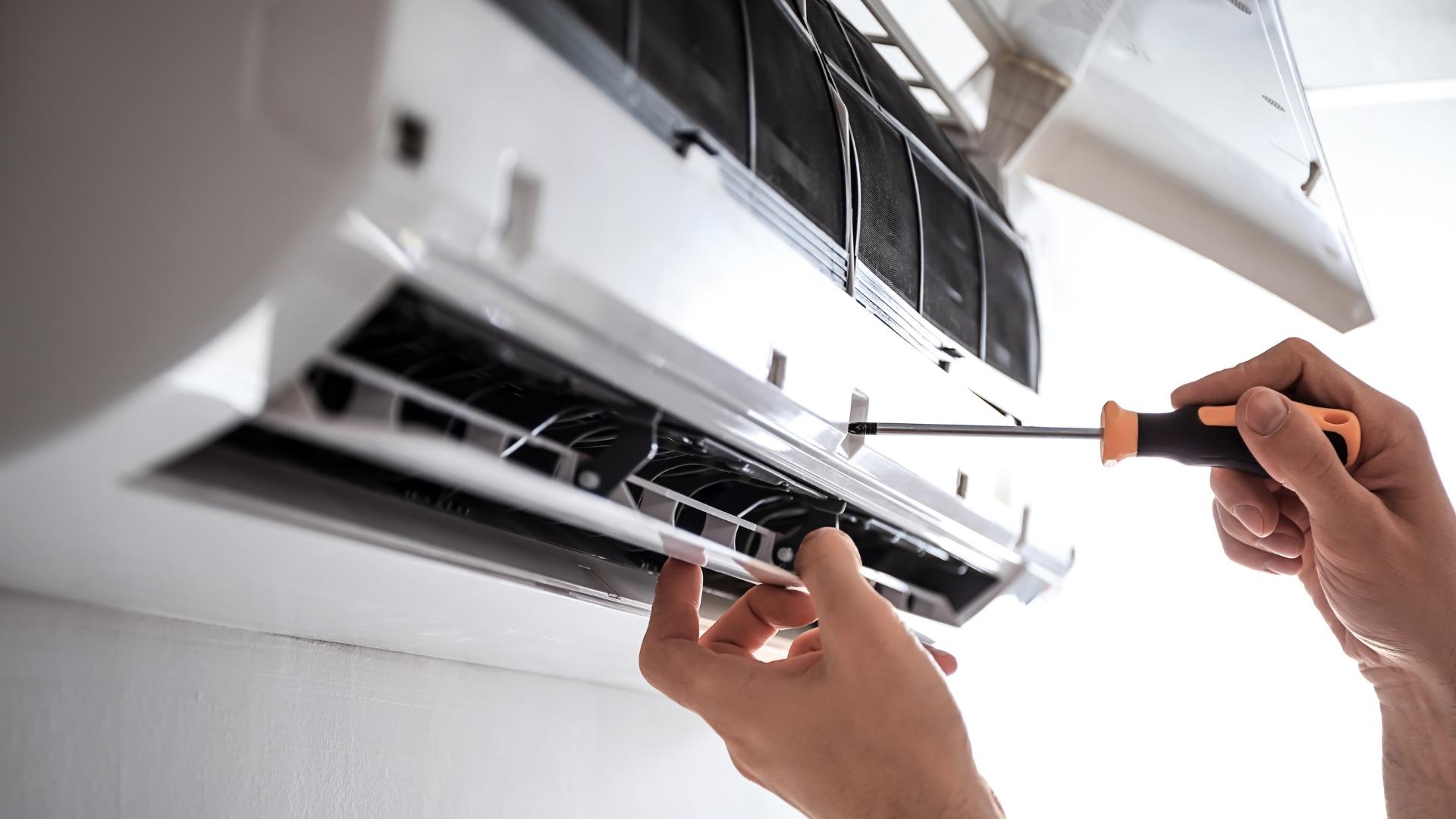hvac technician hands with screwdriver close up repairing ac pompano beach fl