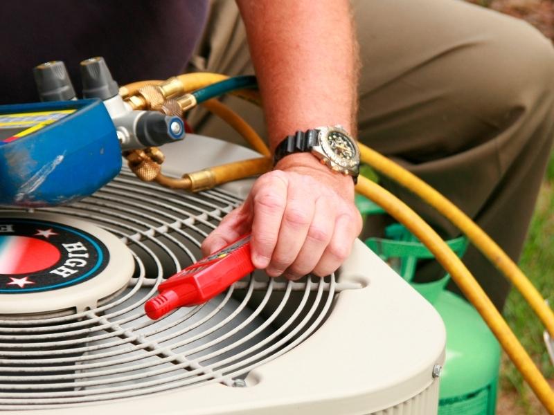 technician close up with tools repairing hvac unit pompano beach fl