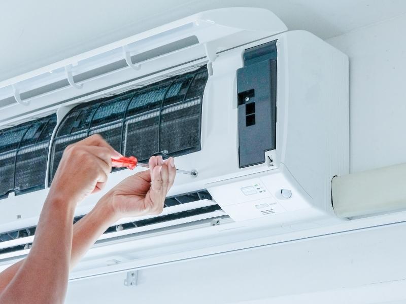 technician hands with screwdriver installing ac unit fort lauderdale fl